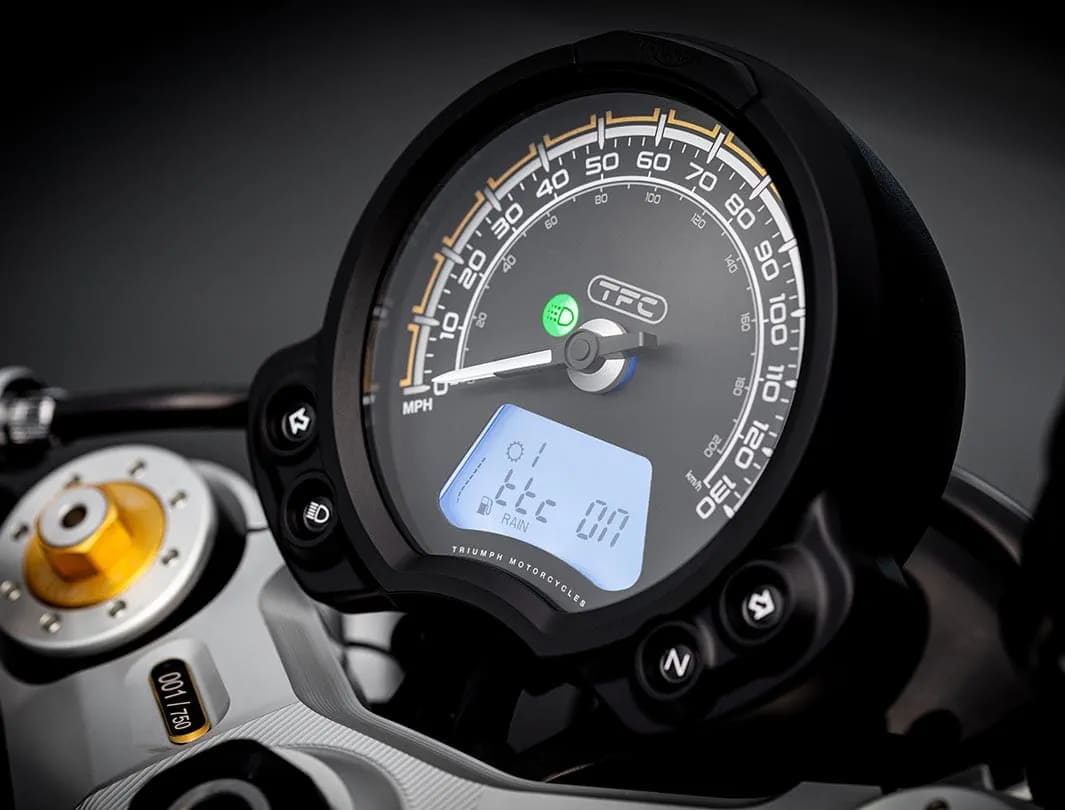 Close-up shot of the Triumph Bobber TFC's unique TFC-branded dial face with gold top yoke